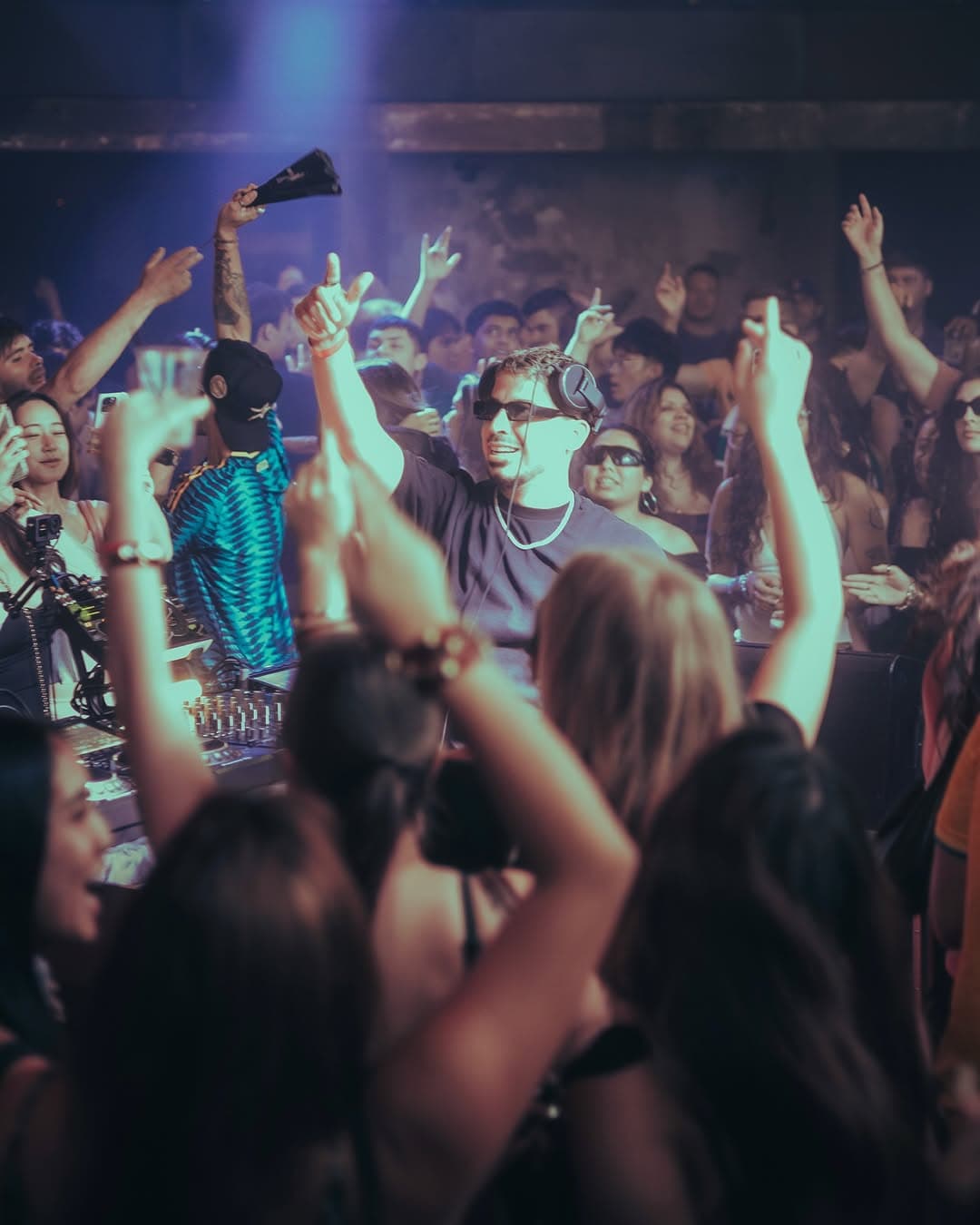 The crowd with hands in the air on the QUEMA dance floor