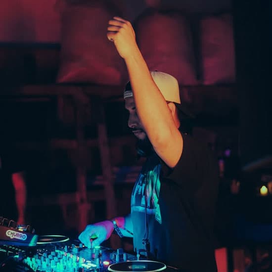 A DJ at the decks at District Atlanta