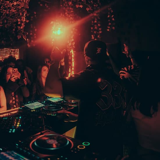 A DJ in a dark booth